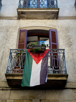 Palestinian flag displayed from the wrought iron balcony of a residential building in O&ntilde;ati, Gipuzkoa, Basque Country, Spain, as a public expression of solidarity and political support.
