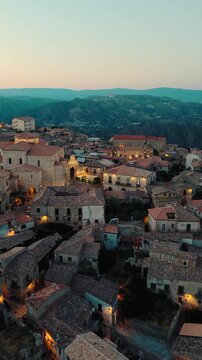 Aerial night view of Gerace, Calabria, with the illuminated cathedral