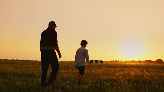 Grandfather and grandson walking together across a peaceful field at golden sunset, sharing quiet moments of connection, reflection, and intergenerational bonding
