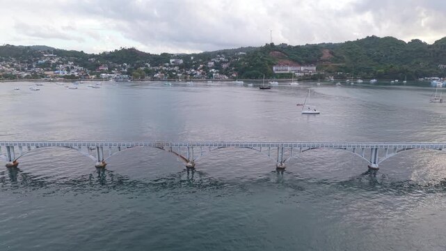 Aerial View of Samana Bridge and Sailboats Along Tropical Coast