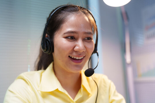 Smiling Customer Service Assistant Wearing Headset at Call Center