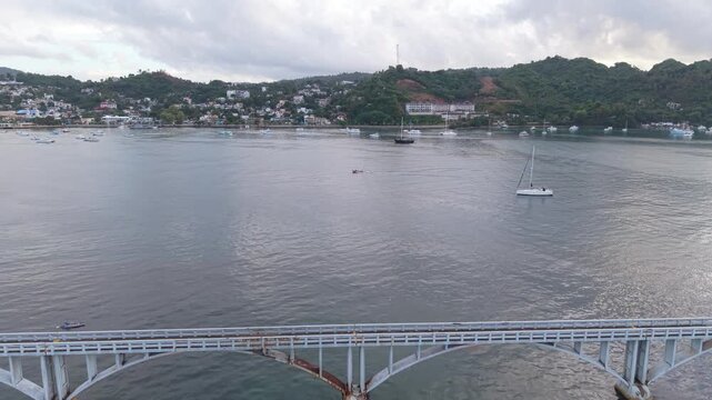 Drone Flight Across Samana Bay from Coastal Bridge to Waterfront Town