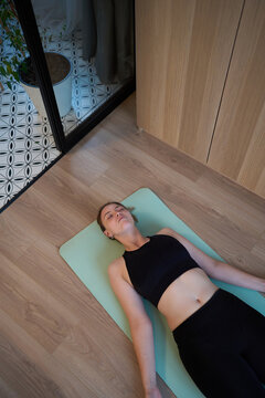Quiet relaxation on yoga mat in soft peaceful mood