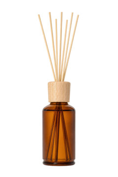 Elegant amber glass diffuser bottle with wooden cap and natural reed sticks, captured on a clean white background