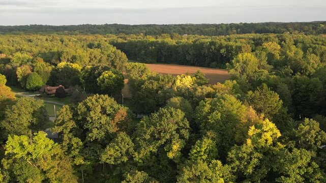 Aerial over Berrien Springs, Oronoko Charter Township, Michigan. A rural community with farms. Approaching Lake Chapin, a dammed lake along the St. Joseph's River.