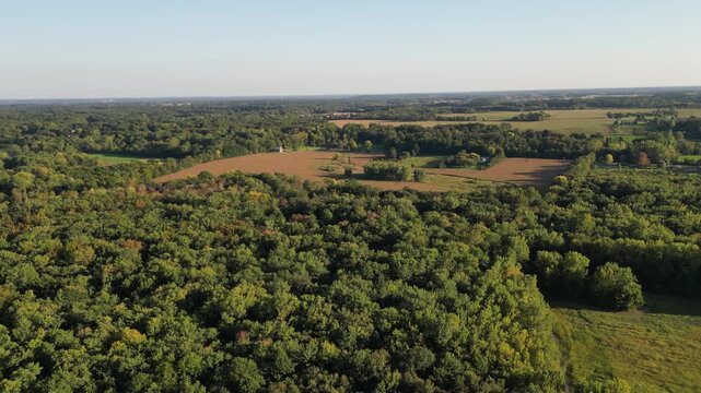 Aerial over woods in Berrien Springs, within the Oronoko Charter Township, Michigan, United States. A rural community with farms and lakeside or riverside homes and vacation properties. 
