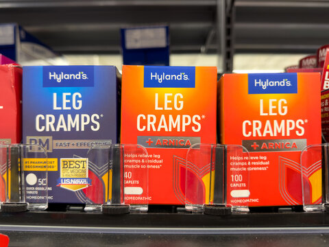 Frisco, Texas, USA - August 31th, 2026: homeopathic arnica fast effective Hyland Leg Cramps relief caplets orange boxes on Walmart pharmacy display