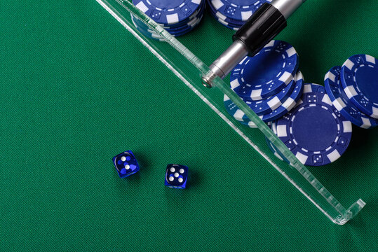 Dice and chips on a green felt gaming table, a poker game in a casino. Casino dice