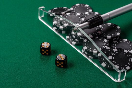 Dice and chips on a green felt gaming table, a poker game in a casino. Casino dice
