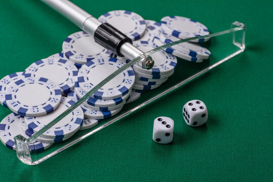 Dice and chips on a green felt gaming table, a poker game in a casino. Casino dice
