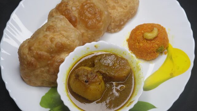 Indian food, poori or luchi. A deep fried bread made from whole wheat flour and Served with Potato curry, or alu dum or alu masala curry. breakfast concept.