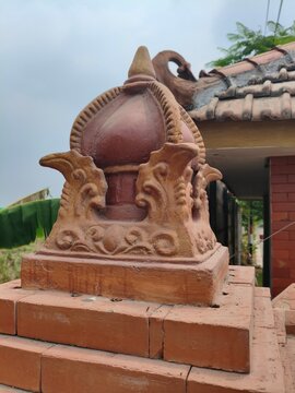 Traditional Javanese Terracotta Roof Ornament on Red Brick Pillar