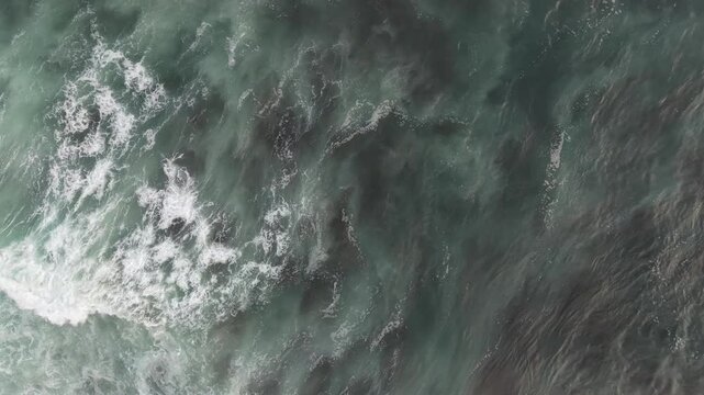 Top Down Aerial View of Powerful Ocean Waves and White Sea Foam