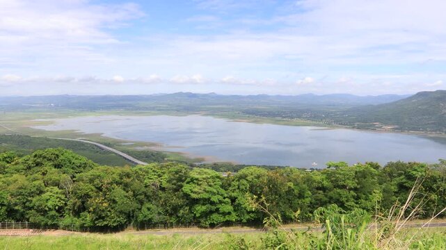 A scenic video view from the high-altitude wind turbine viewpoint at Khao Yai Thiang, Korat, Thailand, featuring beautiful scenery that overlooks the Lam Takhong Dam and wind energy infrastructure.