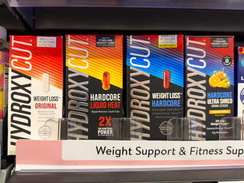 Frisco, Texas, USA - August 31th, 2026: Hydroxycut weight loss original and hardcore liquid heat boxes arranged in protective trays on Walmart pharmacy shelf