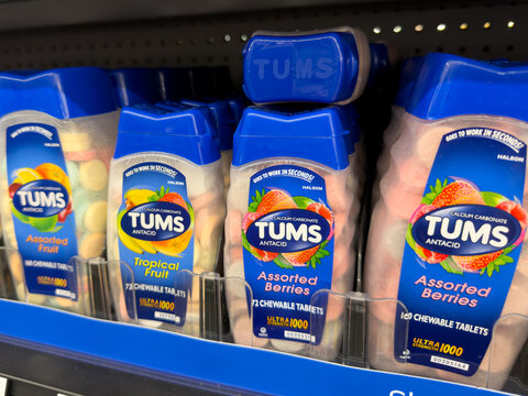 Frisco, Texas, USA - August 31th, 2026: Tums antacid ultra strength chewable tablets plastic bottles arranged neatly on shelf in Walmart pharmacy display