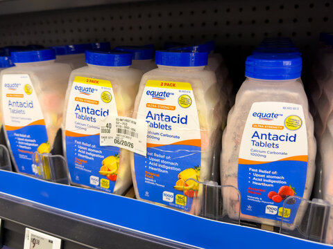 Frisco,Texas, USA - August 31th, 2026: Equate antacid chewable tablets ultra strength twin pack bottles standing on shelf in Walmart pharmacy display