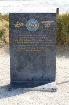 Close-up of stone table remembering Angelos Chatas US Navy frogman at memorial site at Utah Beach on a sunny summer day. Photo taken July 16th, 2026, Utah Beach, Normandie, France.