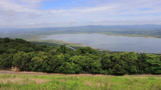 A scenic video view from the high-altitude wind turbine viewpoint at Khao Yai Thiang, Korat, Thailand, featuring beautiful scenery that overlooks the Lam Takhong Dam and wind energy infrastructure.