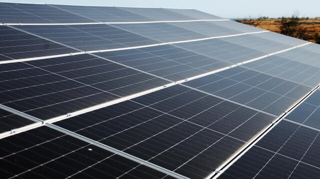 Long rows of solar panels form a modern rooftop energy system. Clean energy, renewable power and sustainable development concept.