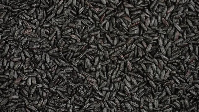 Black rice close-up, top view, rotating