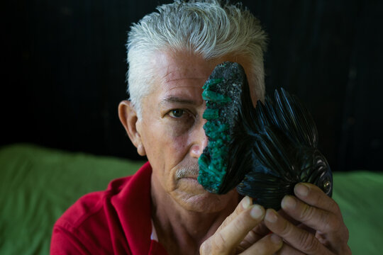 Man holding rough emerald mining specimen