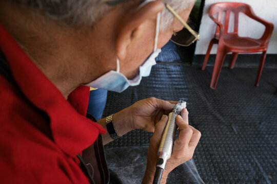 Artisan sculpting stone creating traditional handcrafted souvenir
