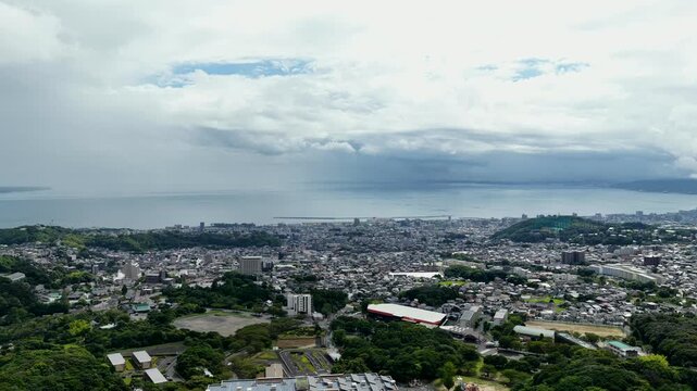 Aerial drone footage over coastal city of Beppu, Oita, Japan