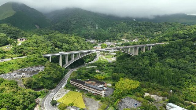 Aerial drone footage of elevated bridge and mountain scenery in Beppu, Oita, Japan
