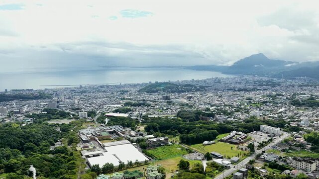 Aerial drone footage of Beppu cityscape and bay in Oita, Japan