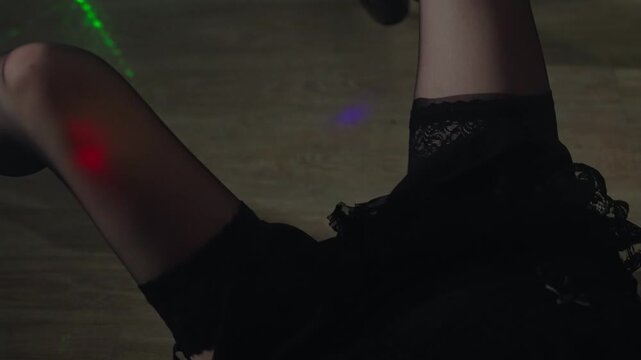 Female pole dancer legs in high heels.