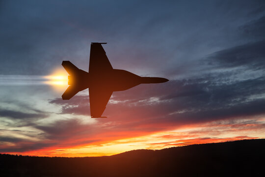 Air Force Day. Aircraft silhouette on background of sunset. Combat flight of interceptor on a mission.