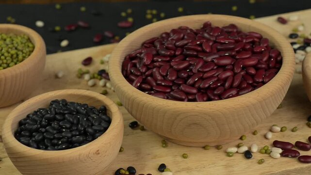 Different kinds of beans in wooden bowls 