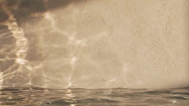 Beautiful water caustics reflection on a beige textured wall with gentle ripples on the water surface
