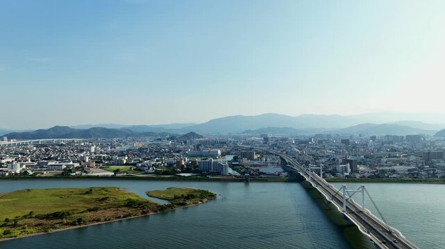 Aerial drone footage of cable-stayed bridge and Yoshino River in Tokushima, Japan