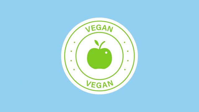 Vegan food label sticker animation with a green apple fruit with leaf inside circular on a transparent background. Vegan food certification. Seamless animated icon. 4K video overlay isolated element.
