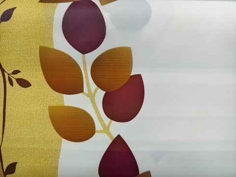 Close-up of a fabric pattern featuring stylized autumn leaves in shades of purple, orange, and red on a white background.