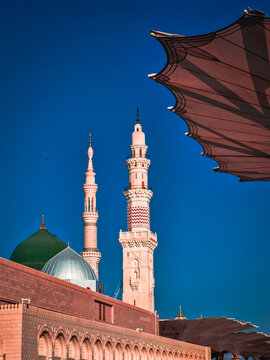 Exterior view of minarets and green dome of a mosque taken off the compound. masjid Al Nabawi minaret and green dome in Madinah, Saudi Arabia