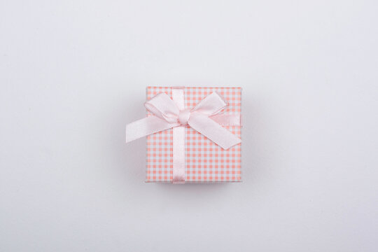 Pink gift with bow on a white background.