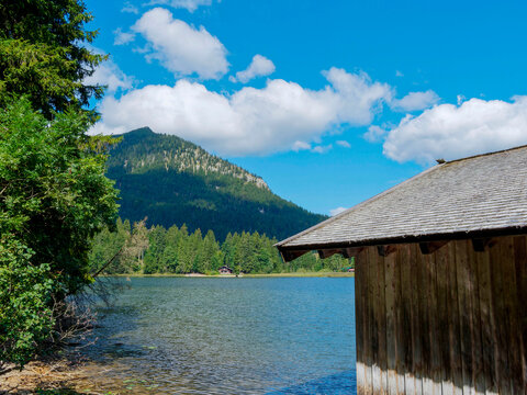 Lake Spitzingsee in the Bavarian Alps. Boathouse located on the northwest shore with a view of the Brecherspitz summit