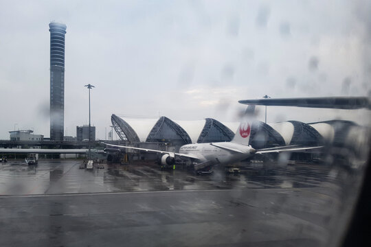 Bangkok, Thailand - April 07, 2018 -  Japan Airlines boeing 787 dreamliner connected to a jetway bridge at Suvarnabhumi Airport in Bangkok Thailand on a rainy day.