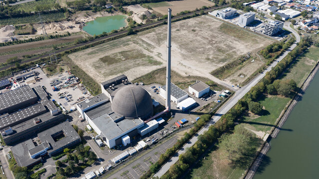Aerial view of the Mulheim-Karlich Nuclear Power Plant with its iconic dome-shaped reactor building and tall chimney, situated near the Rhine river in Urmitz, Rhineland-Palatinate, Germany.