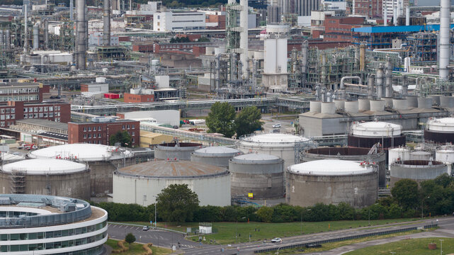 Aerial view of the Dormagen-Bayerwerk chemical plant with large storage tanks, pipe networks, and industrial buildings in an expansive facility. Cologne, Nordrhein-Westfalen, Germany.