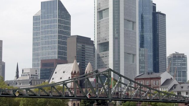 Tilt shot of downtown Frankfurt, Germany, the Eiserner Steg, and the Main River.