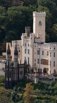 Aerial view of Stolzenfels Castle featuring its historic towers, gothic chapel, and surrounding lush forest in Koblenz, Rheinland-Pfalz, Germany.