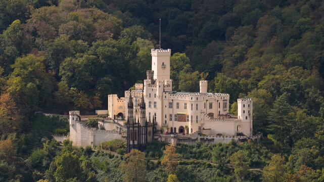 Aerial view of Stolzenfels Castle surrounded by dense forest and historic architecture in Koblenz, Rheinland-Pfalz, Germany.