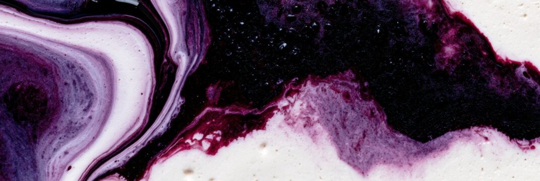 Rich black blackberry liquid swirls with white cream, showing fluid movements and textures in a close-up view of the mixing process.