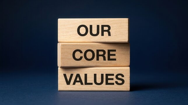Wooden blocks with the words Our Core Values stacked on a blue background.