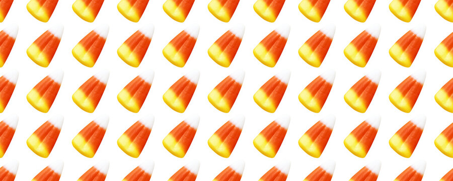 Repeating seamless pattern of candy corn pieces on transparent background	