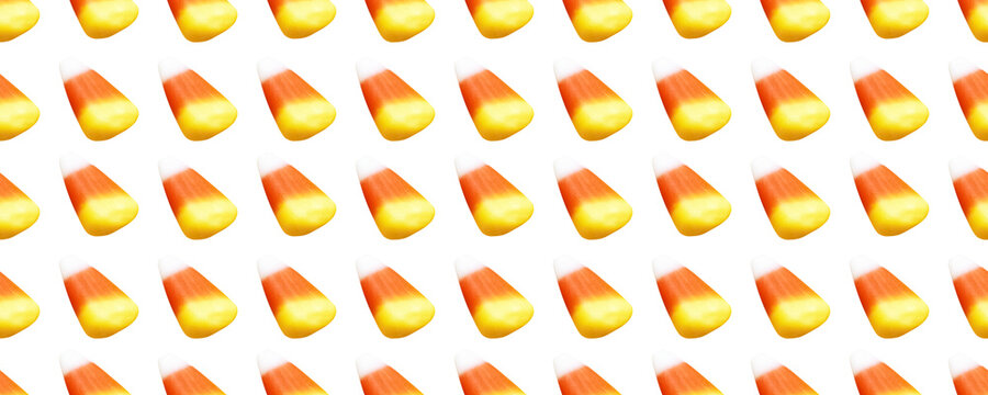 Repeating seamless pattern of candy corn pieces on transparent background	